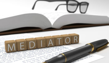 Mediator  - dices containing the word mediator, a book, glasses and a fountain pen.